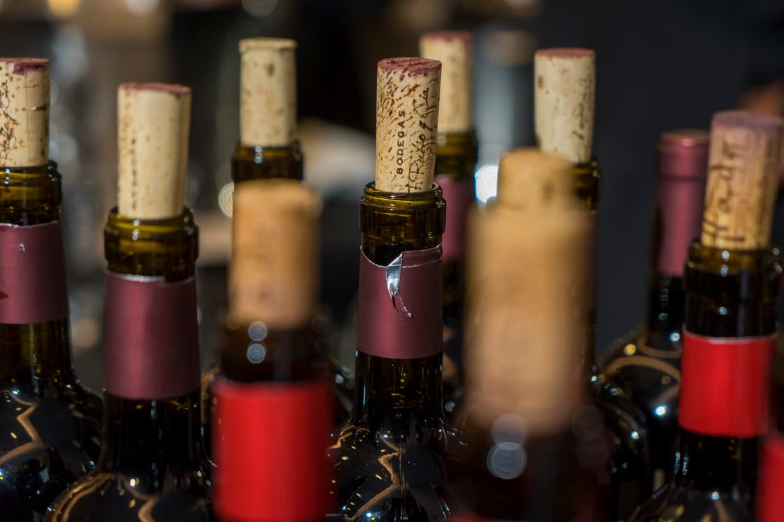 A row of corked wine bottles ready for the live and silent auction